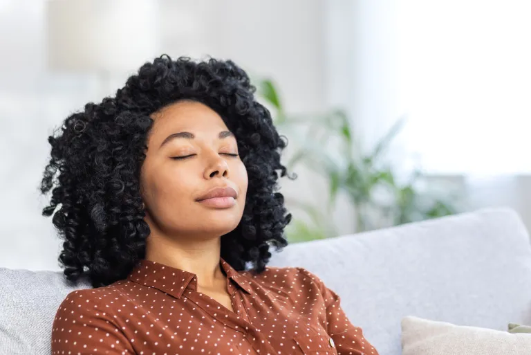 Woman relaxing with eyes closed during stress management